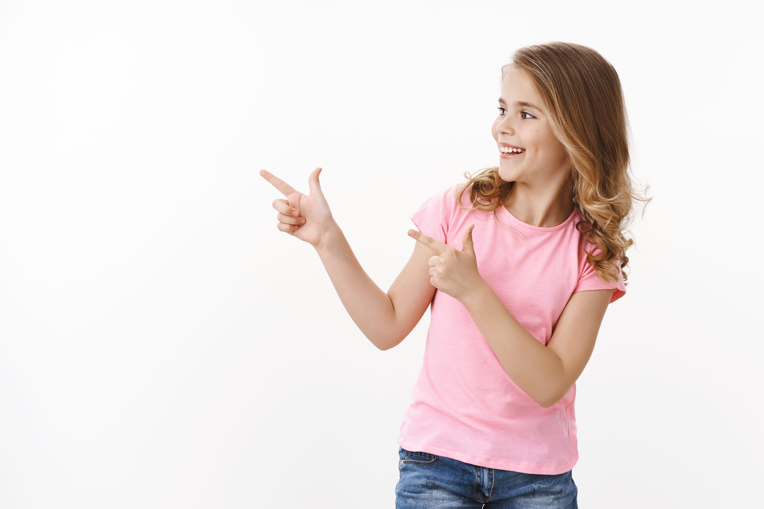 carefree-cheerful-smiling-happy-blond-little-girl-turn-left-pointing-finger-pistols-copy-space-greeting-school-friends-grinning-delighted-child-check-out-cool-copyspace-promo-white-background